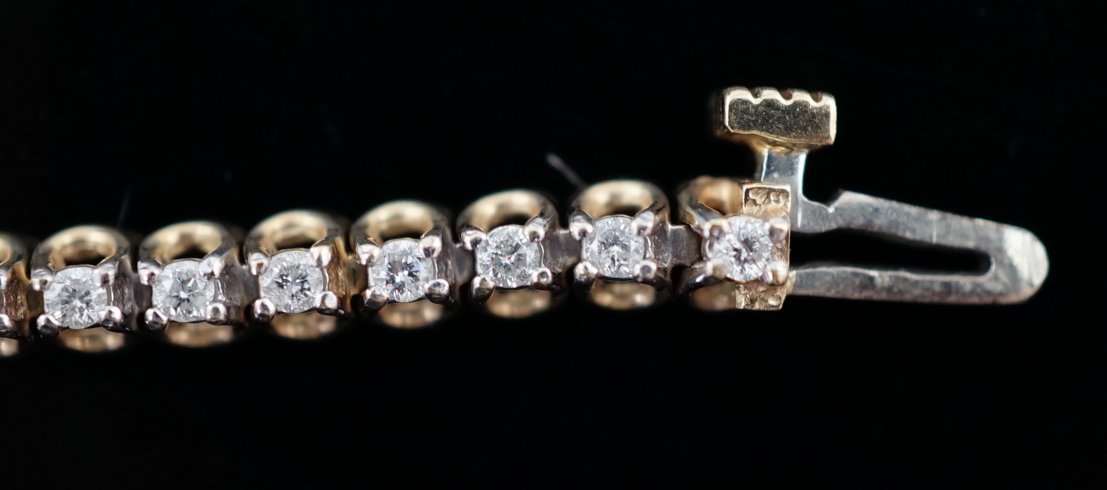 A modern 9ct gold and diamond chip set line bracelet